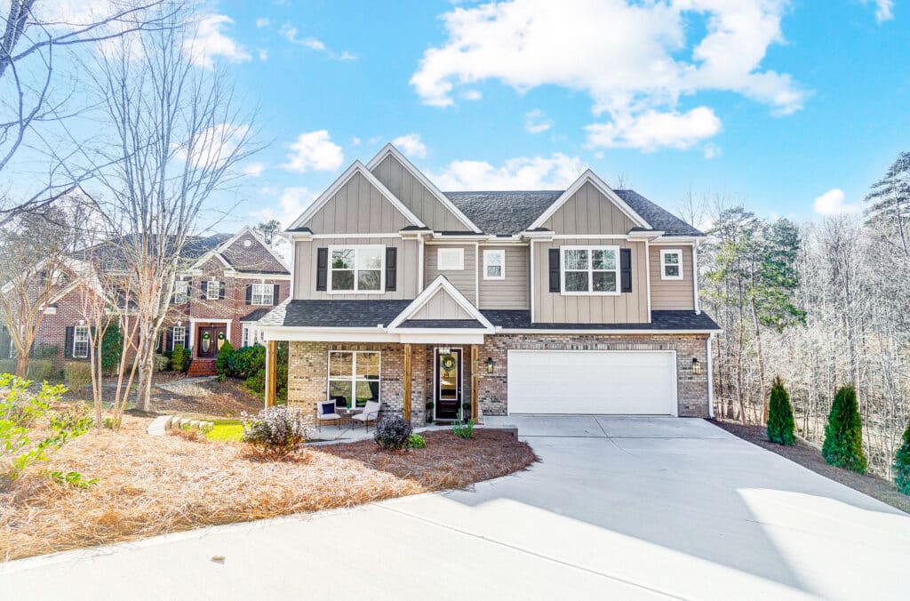 Large modern two-story house with garage, front porch, and well-maintained exterior
